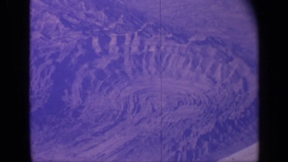 1970 India 8mm frame showing crater-like rocky patterns with strong purple aging and visible film borders.
