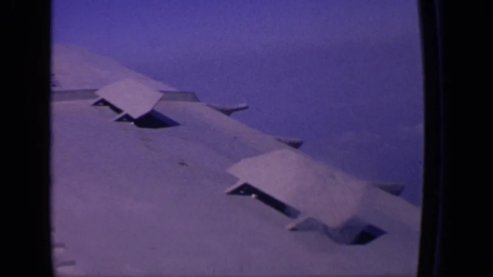 Closer 1970 8mm view of the aircraft wing with extended flap sections, filmed from a passenger window over India.