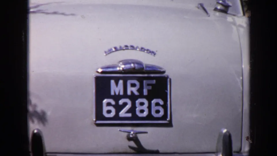 Close view of a light-colored classic car rear in India, showing chrome trim and the readable license plate MRF 6286.