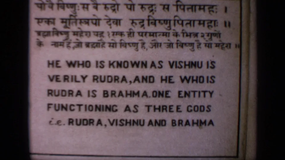 Close-up of a Sanskrit and English sign describing Vishnu, Rudra, and Brahma in a Hindu religious context.
