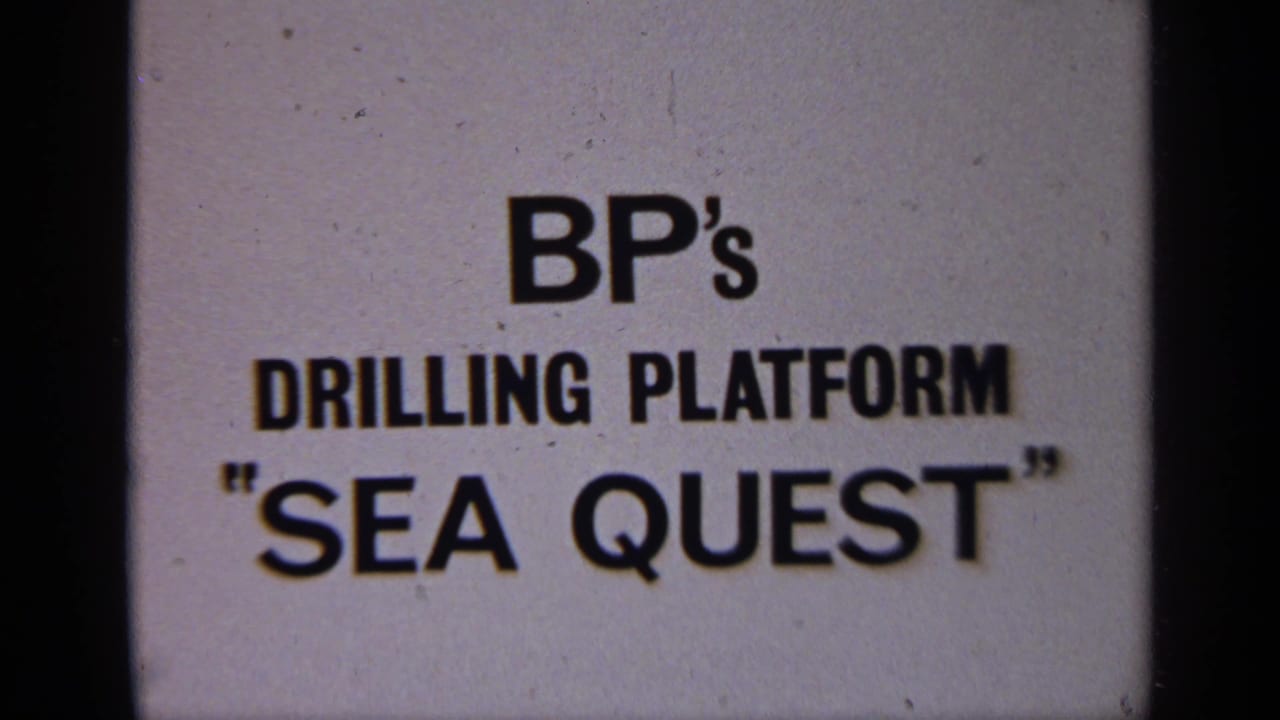 1970 United Kingdom 8mm frame showing a BP drilling platform Sea Quest title card on a pale background.