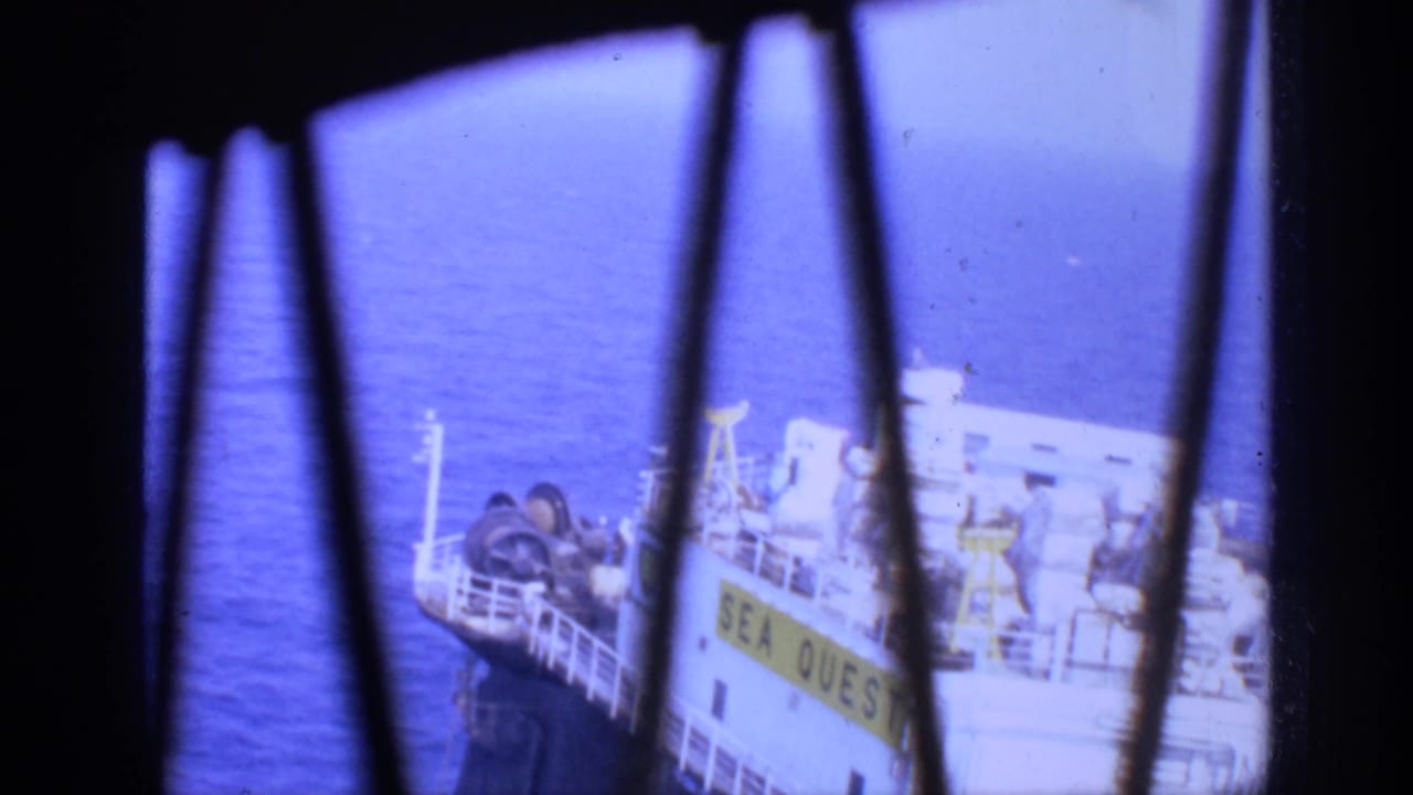 1970 United Kingdom 8mm frame showing the SEA QUEST vessel at sea through vertical window bars.