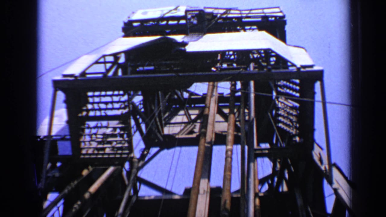 Metal rig platform with grating and vertical supports seen from below.