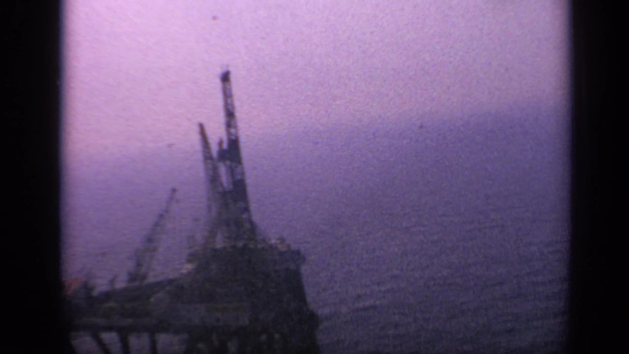 Offshore structure near the left side of the frame with open sea stretching behind it.
