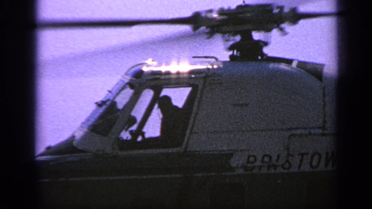 Side cockpit view of the helicopter with crew silhouettes and Bristol marking partly visible.
