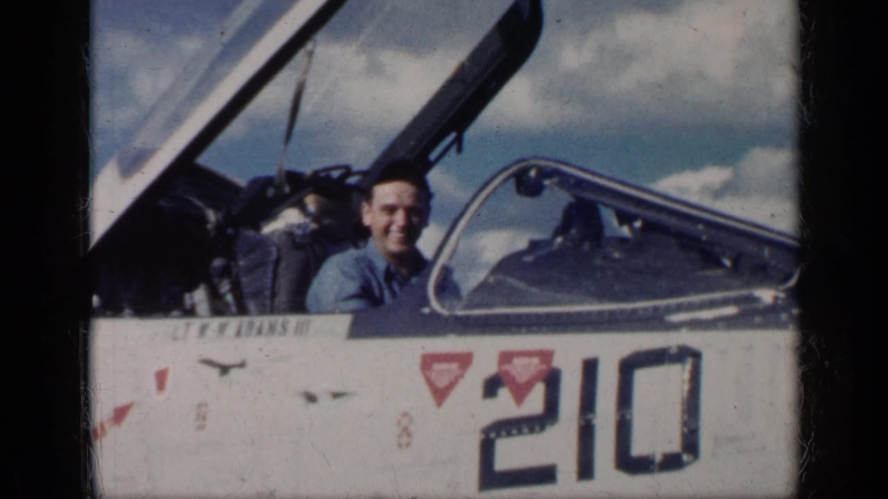 In Cuba in 1962, a young man smiles from an open military jet cockpit as number 210 and red triangular markings show on the fuselage.