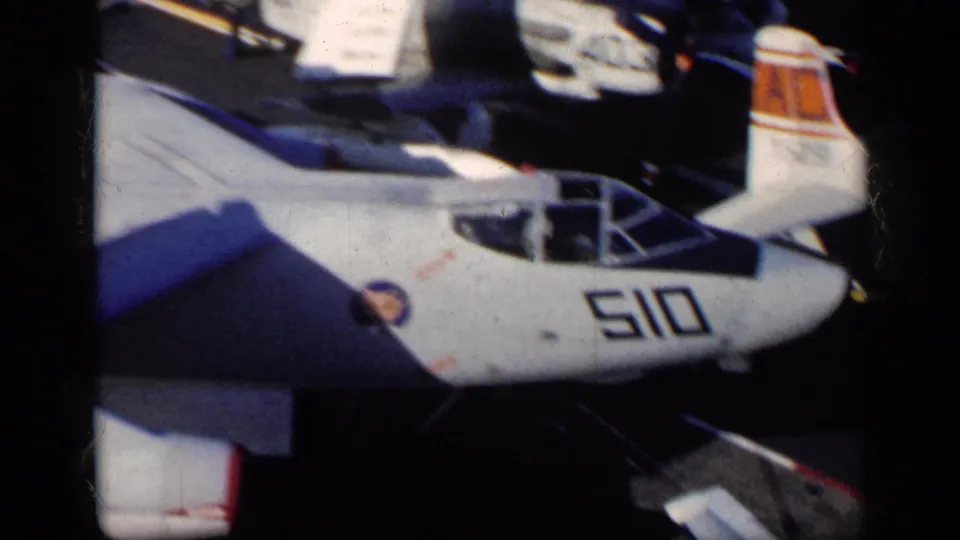 1962 8mm frame from supplied Cuba metadata showing the nose and cockpit of a white U.S.-marked military jet numbered 510.