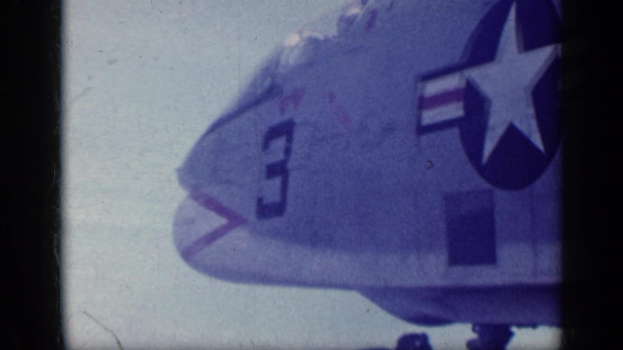 Close view of a U.S. Navy jet nose marked with number 3 and star insignia.
