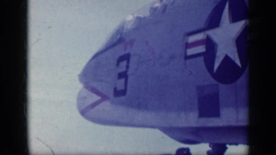 1962 Cuba footage shows the front section of a U.S. Navy jet with number 3 and star-and-bar insignia near the cockpit area.