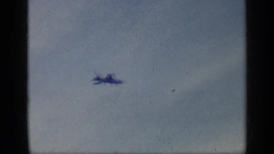 A small military aircraft appears in flight against a pale sky in this 1962 Cuba naval aviation clip.