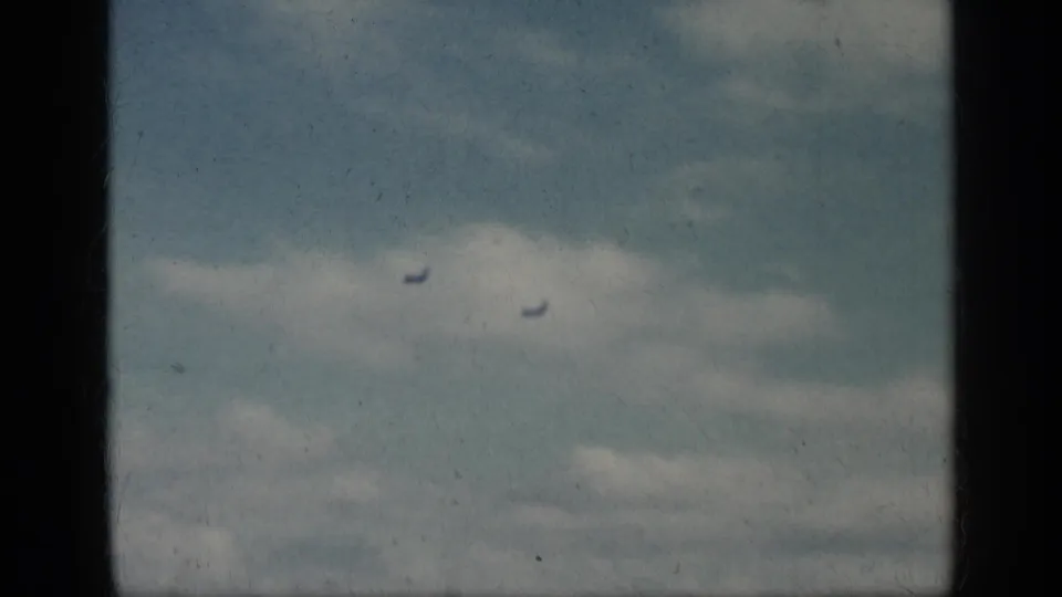 Two small jet silhouettes are seen in the sky within the 1962 Cuba-labeled home-movie sequence.