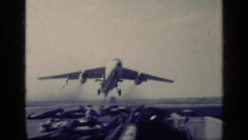 A large aircraft takes off from an airfield in grainy 1962 Cuba-labeled 8mm footage.