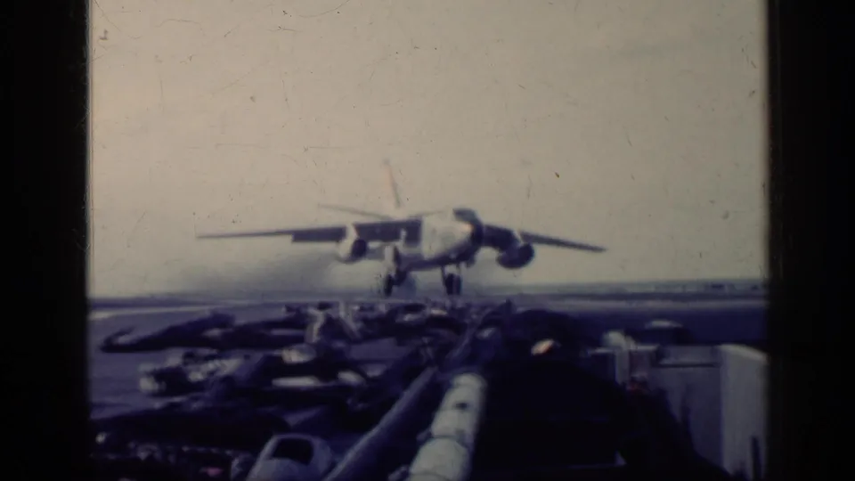 1962 Cuba airport scene showing an airliner touching down or landing low over the runway, with ground details in front.
