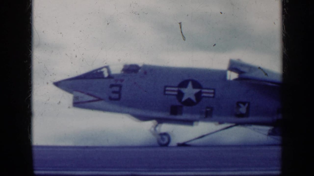 Military jet nose and U.S. star marking on a deck or runway.