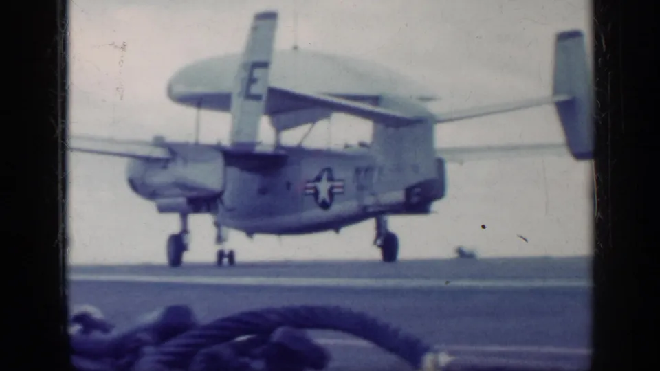 U.S. Navy twin-prop aircraft marked with star insignia and number 711 on a carrier deck, consistent with the supplied 1962 Cuba metadata.