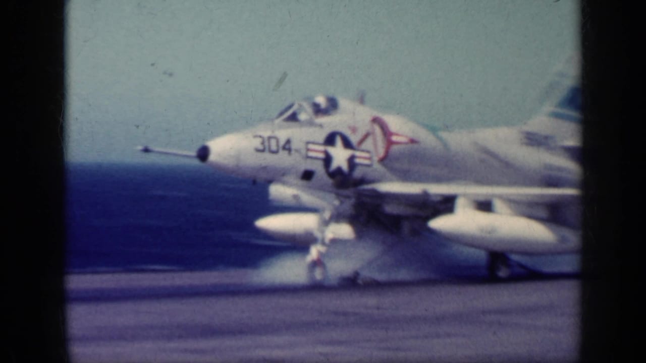 1962 Cuba metadata supports this view of a U.S. Navy jet marked 304 on a carrier flight deck with open sea beyond.
