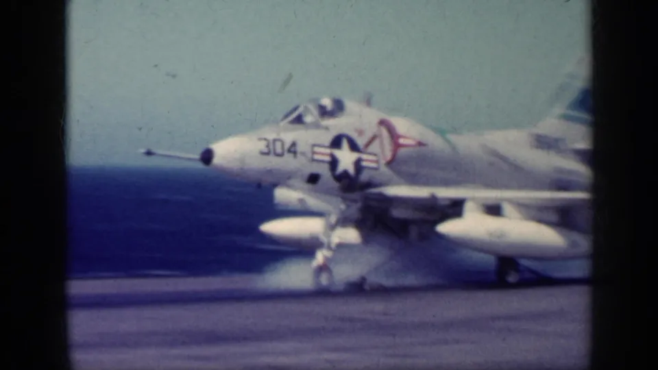 1962 Cuba metadata supports this view of a U.S. Navy jet marked 304 on a carrier flight deck with open sea beyond.
