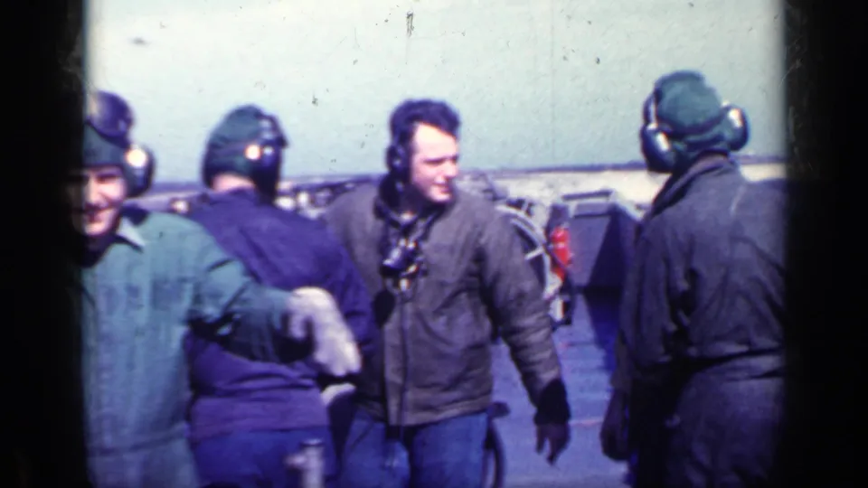 A group of men in flight clothing, caps, and headsets move around airfield equipment in the supplied Cuba 1962 clip.