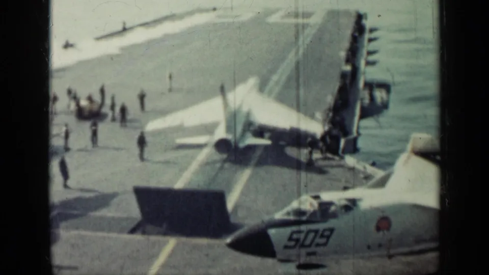 The frame shows continued carrier deck preparation around a military jet, supported by Cuba 1962 metadata and visible aircraft number 509.