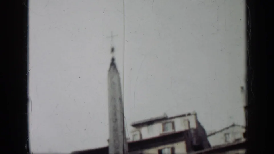 1962 Cuba 8mm frame with the monument centered against a bright sky and building rooftops at the edge.