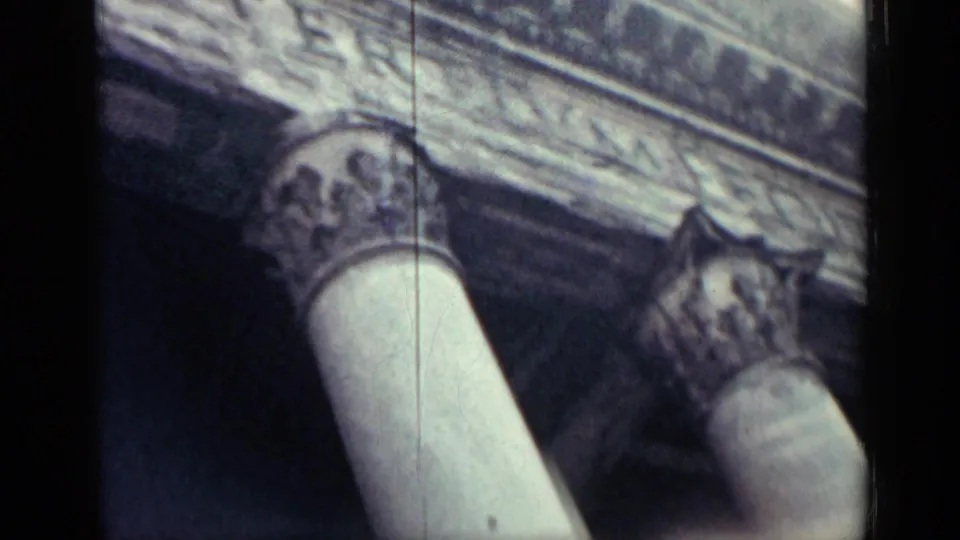 1960s 8mm close view of carved capitals and stone entablature, filmed at an oblique angle.