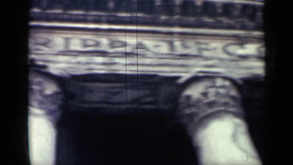 8mm travel frame showing a partial GRIPPA inscription on stone entablature above columns, likely part of a classical landmark.