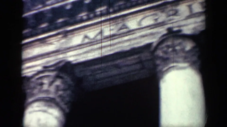 Close 8mm view of carved stone fountain detail in Cuba, with soft focus, dark gate edges, and visible film grain.