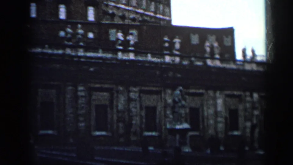 1962 Cuba 8mm view of an ornate palace facade with rooftop figures, windows and a statue set before the building.