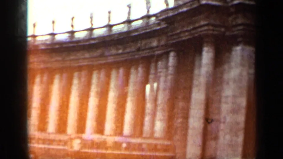 1962 Cuba frame with a closer visitor-shot view of the curved colonnade and a classic car near the lower edge.