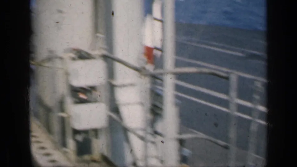 Carrier superstructure details with railings, ladders, pipes, and pale painted ship surfaces in 1962 Cuba-context footage.
