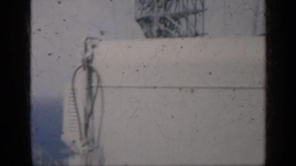 1962 Cuba-associated 8mm frame showing the side of a white vessel, rigging, and blue water beyond the deck edge.
