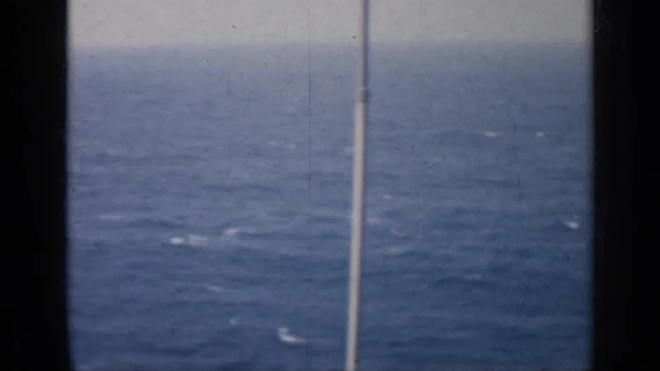 1962 Cuba-associated 8mm frame looking over open water with a slim vertical pole and soft, grainy film texture.