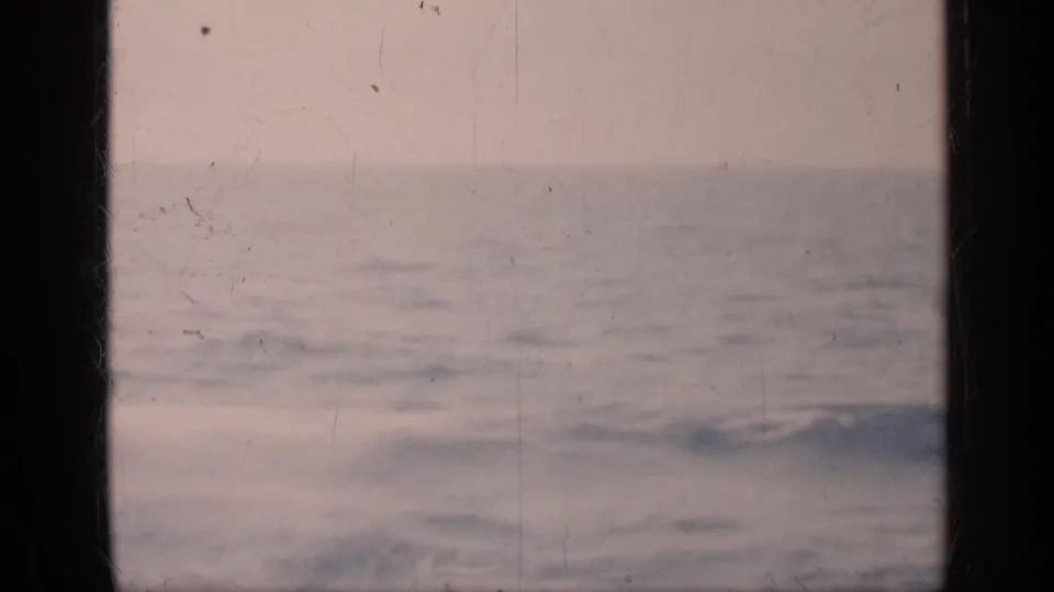 1962 Cuba metadata supports this faded 8mm view of open ocean, small waves, pale sky, and dark frame borders.