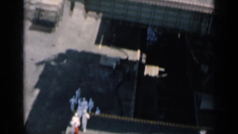 Elevated 1962 Cuba shipboard view with sailors in white near a dark deck opening or structure.