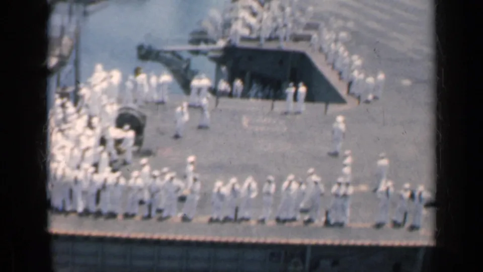 1962 Cuba frame showing sailors arranged along a ship deck edge, filmed from above on 8mm color film.