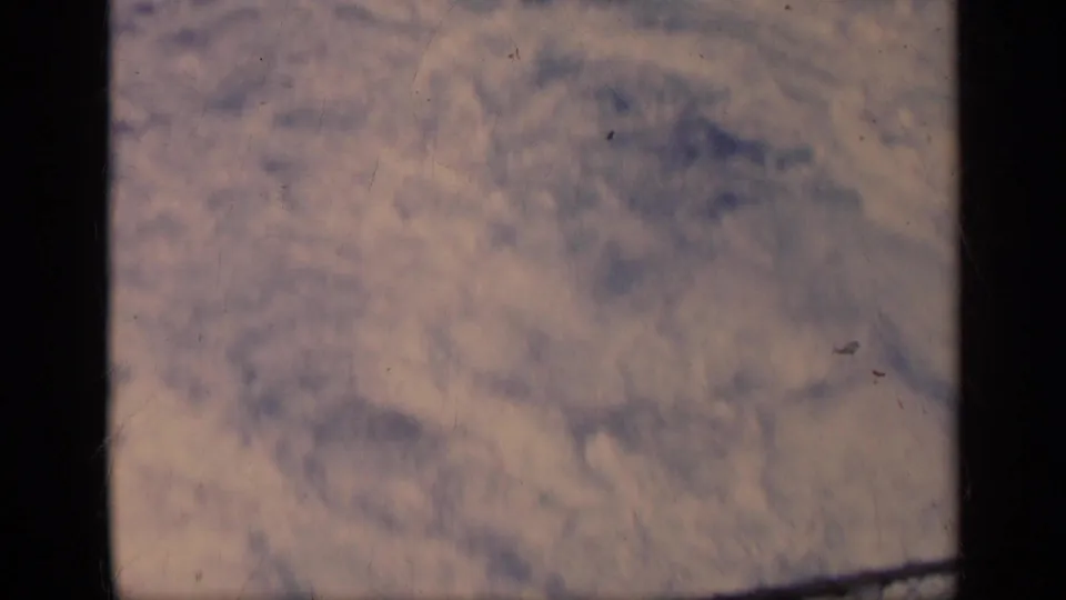 1962 Italy 8mm frame of foamy wake spreading over open sea, with aged color and dark film-frame edging.