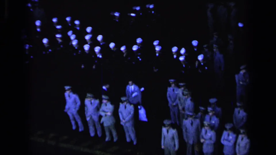 Uniformed U.S. Navy personnel appear gathered in formation during a formal 1962 Italy ceremony, with blue lights above.