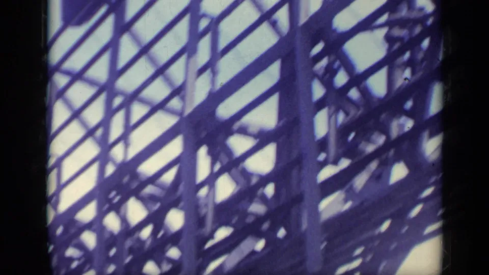 1962 Italy 8mm frame showing dark ship structure, railings, and overhead metal framework from a low onboard angle.