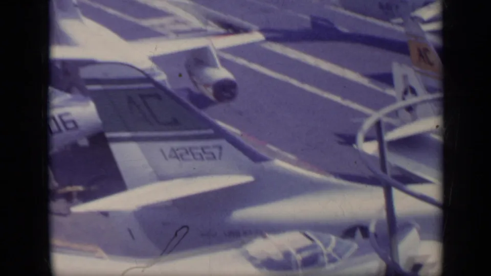 1962 Italy-associated carrier-deck view with Navy aircraft tails and wings, including a visible tail number 142657 and deck railings.