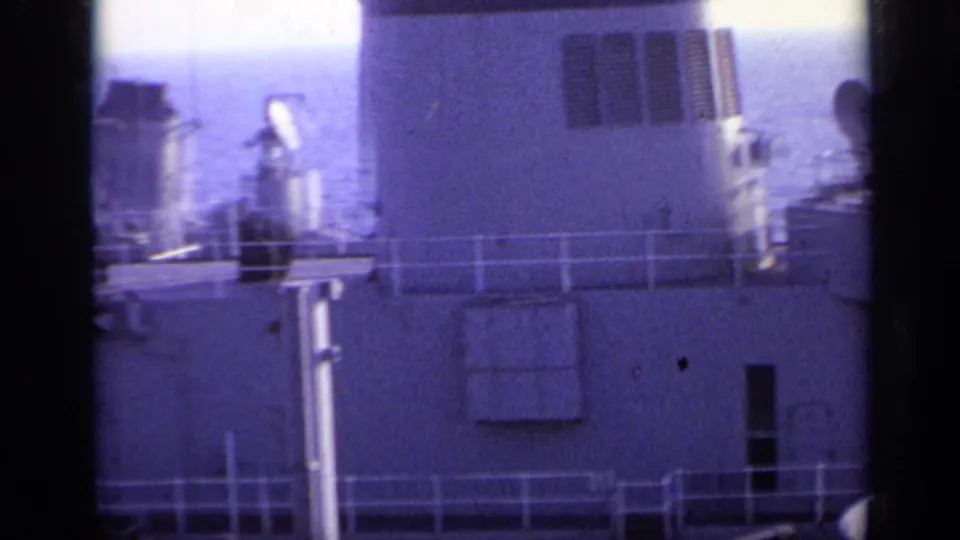 1962 Italy 8mm frame showing the ship superstructure, railings, vents, and deck fittings with sea beyond the vessel.