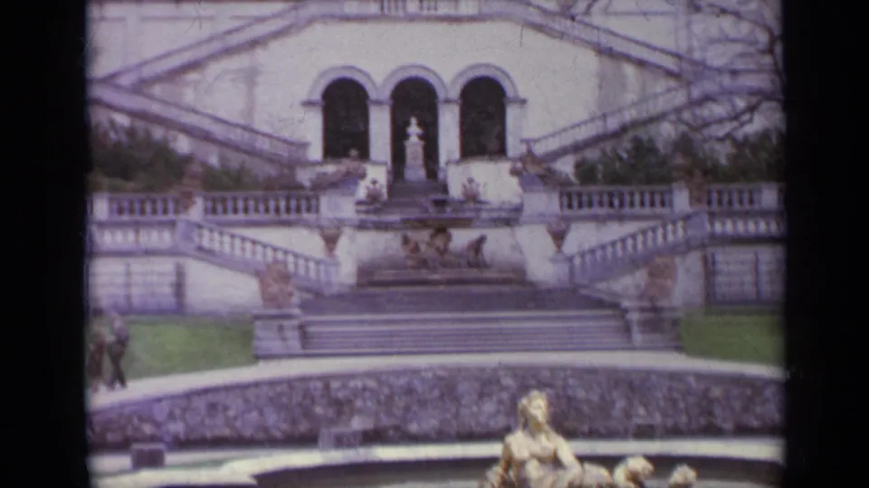 Clearer 1962 Italy frame showing a grand stair monument, arched openings, balustrades, lawn and foreground fountain or sculpture.