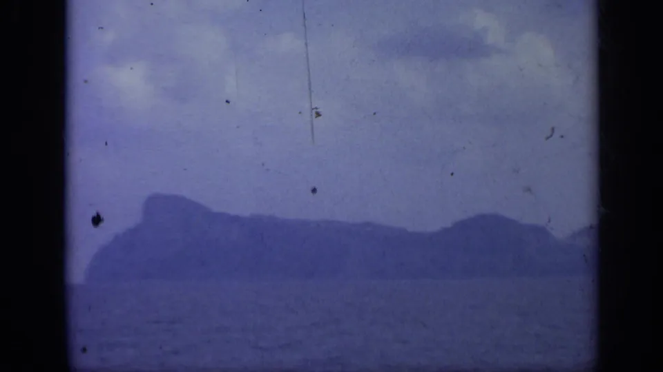 A distant mountainous island appears across the water in the Italy 1962 home-movie footage.