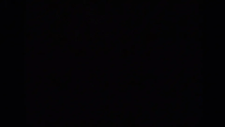 Underexposed 1962 Italian 8mm frame with faint grain, dark density, and a visible horizontal frame-line artifact.