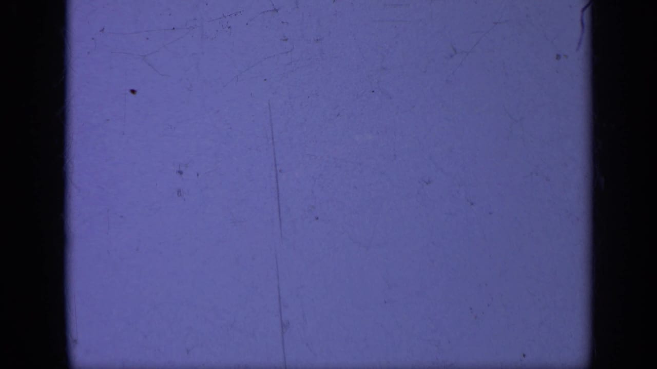 Purplish blank 8mm frame with dark gate edges and visible dust.