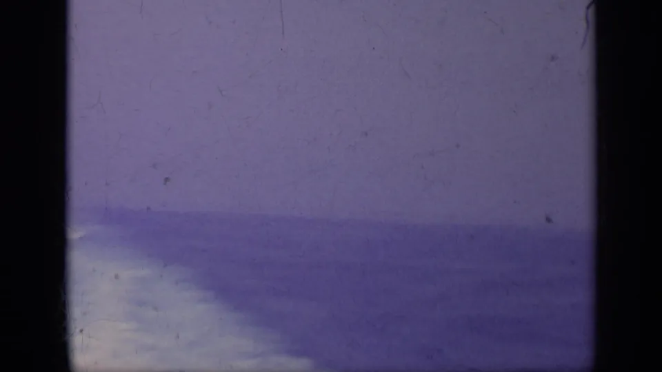 Faded 1962 Italy-associated 8mm view of open sea under a hazy sky, with dark gate edges and visible archival wear.