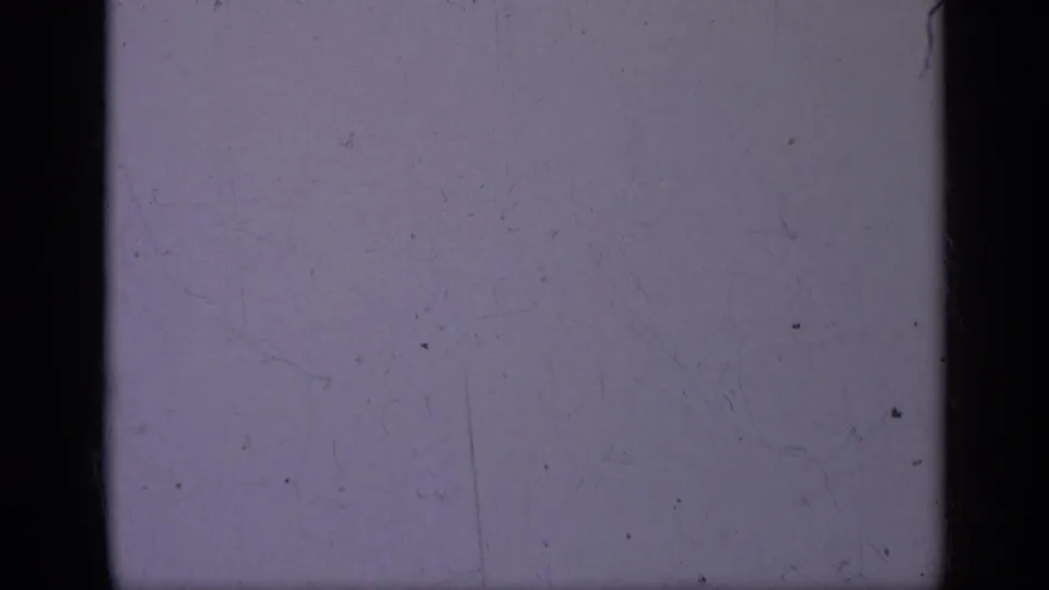 Faded 1962 Italy-associated 8mm frame, mostly empty purple-gray field with scratches, dust, and visible gate edges.