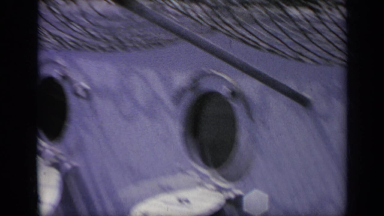 Close view of a textured aircraft surface with dark circular openings.