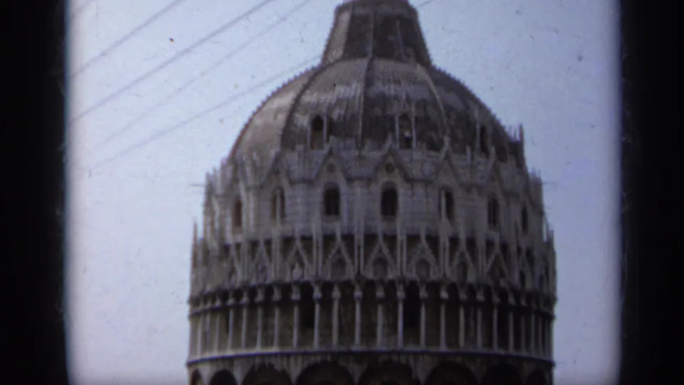 1962 Italy 8mm frame showing a large ornate domed building, likely a public landmark, filmed from a visitor perspective.