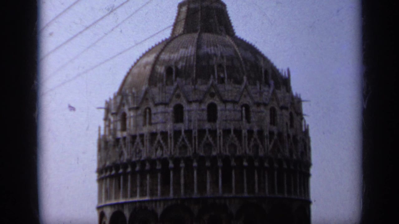 A closer 1962 Pisa tower view shows the ornate upper stone galleries and dome, with dark 8mm frame edges at the sides.