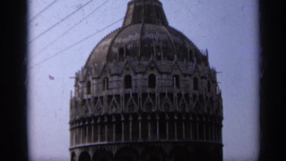 A closer 1962 Pisa tower view shows the ornate upper stone galleries and dome, with dark 8mm frame edges at the sides.